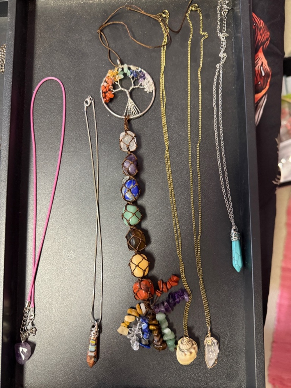 Multistone Tree of Life Gemstone hanger with five other boho style necklaces.